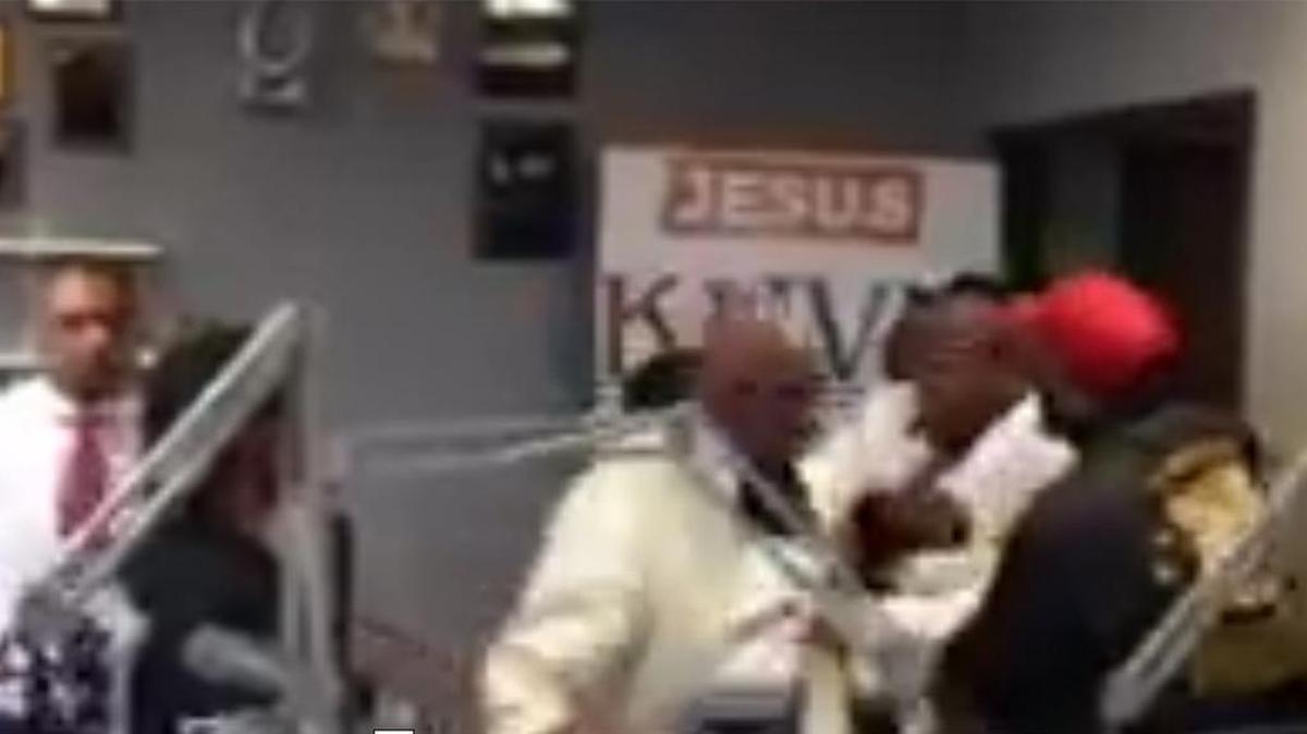 Several people restrain Dwaine Carawau during the “verbal altercation” with John Wiley Price
