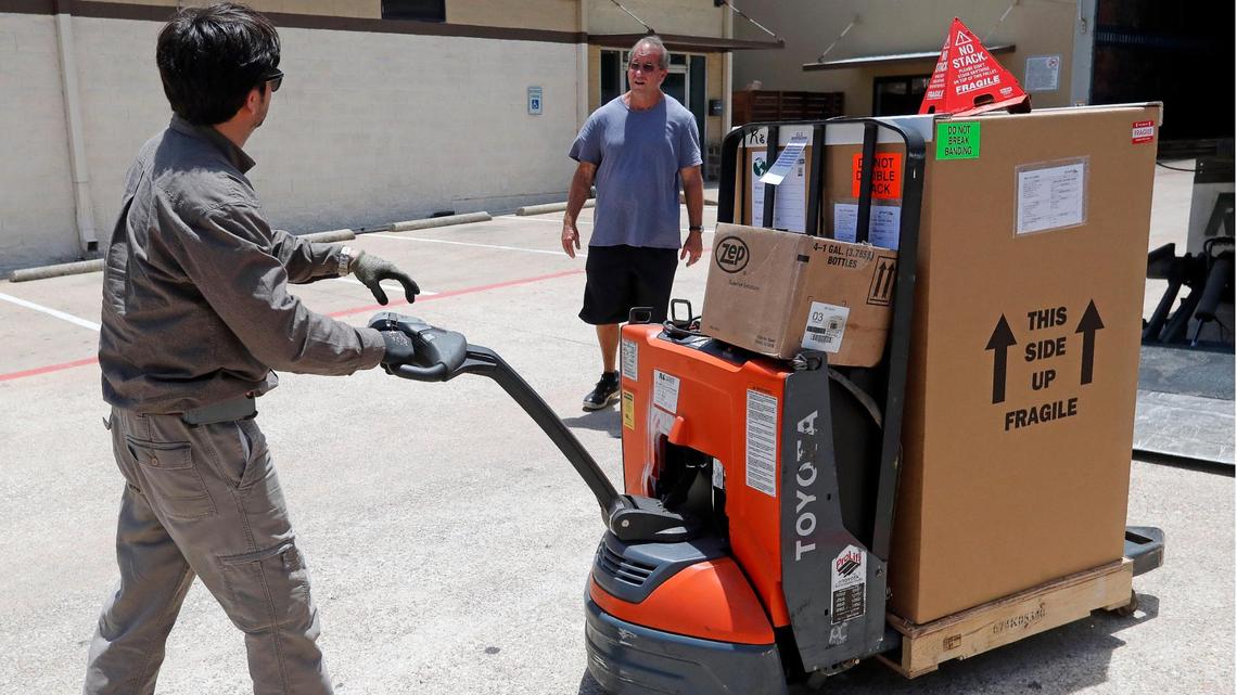 Sergio Tamez of R&L Carriers delivers equipment to Van Roberts at the Allegiance Academy in Euless. The academy will teach core classes as well as intense soccer training.