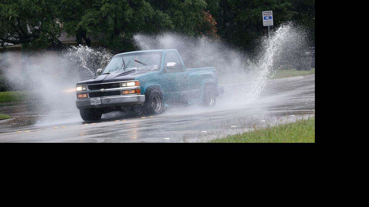
Water stood in big puddles on the street in Fort Worth’s Westcliff neighborhood Wednesday.


