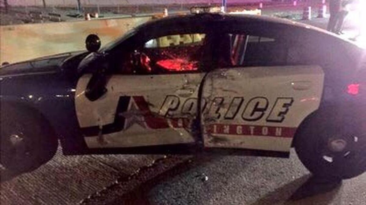 An Arlington police officer was hurt when a man -- who was arrested on suspicion of driving while intoxicated -- driving an SUV struck the police car on I-30 early Saturday morning, according to the Arlington Police Department.