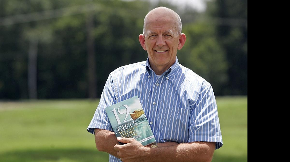 
Dean Posey holds a copy of his book “12 Gifts We Can't Afford to Lose”
