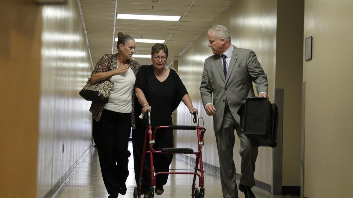 Wife of Joseph Hutcheson, Nicole Hutcheson, consoles Joseph Hutcheson's mother Ruth Boatner, as they are escorted out of Frank Crowley Courts Building by their attorney Scott Lidji in Dallas in2015.