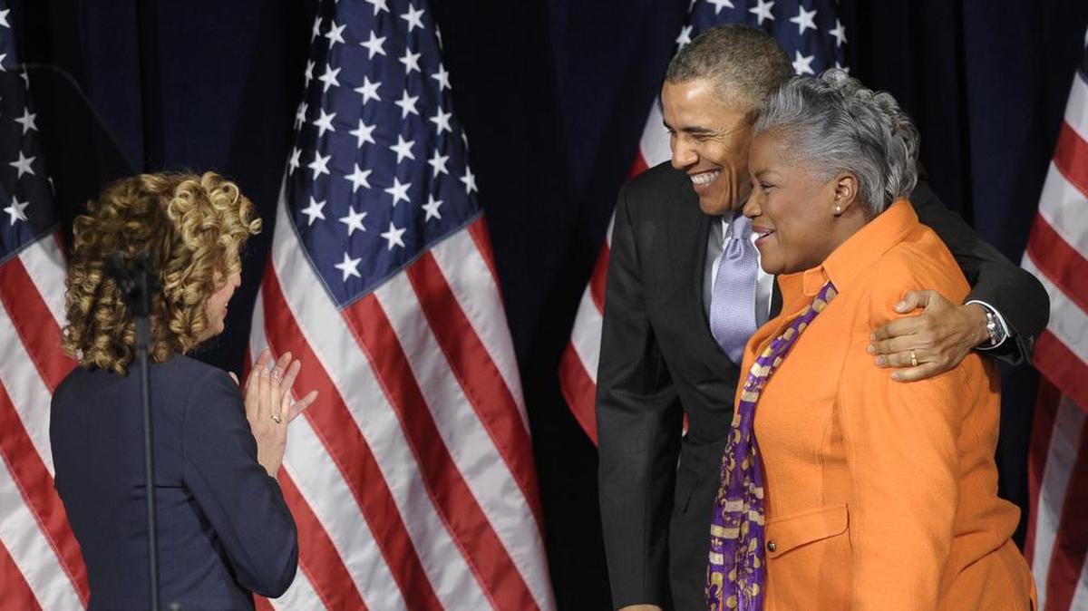 President Barack Obama hugs Democratic strategist Donna Brazile, right, at the Democratic National Committee winter meeting Feb. 28, 2014.