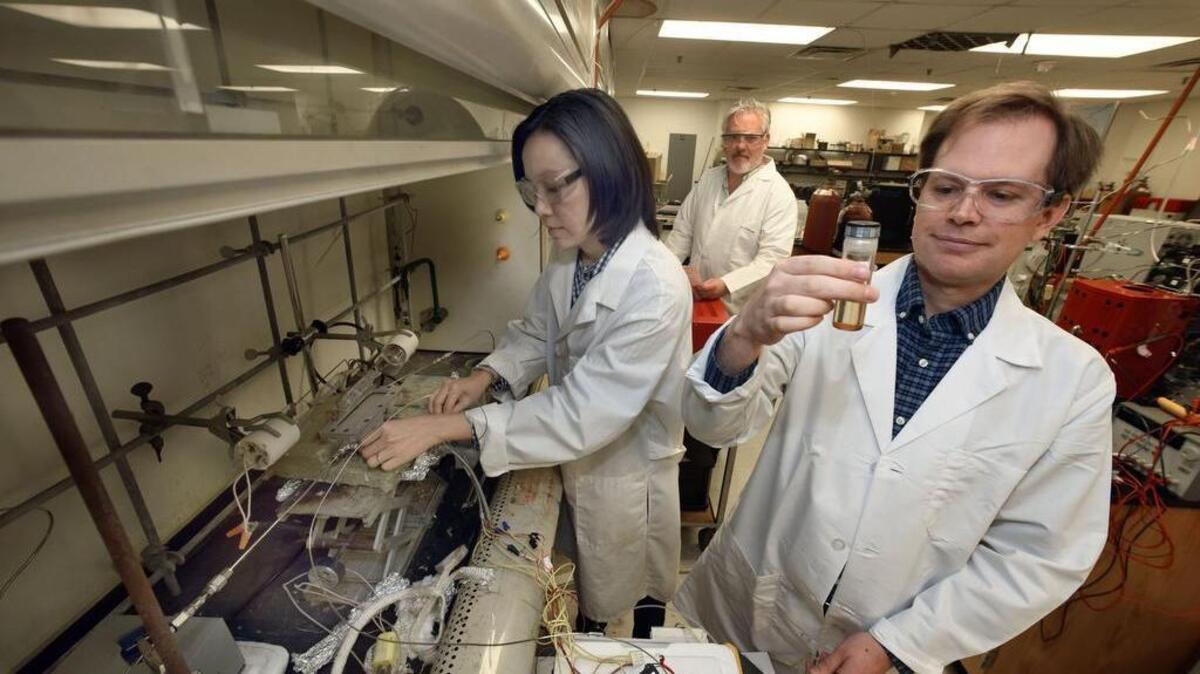 From left, UTA scientists Wilaiwan Chanmanee, Brian Dennis and Fred MacDonnell in their lab. They have found a simple process, using carbon dioxide from the air, to synthesize a liquid fuel similar enough to gasoline that it could replace fuel refined from oil.