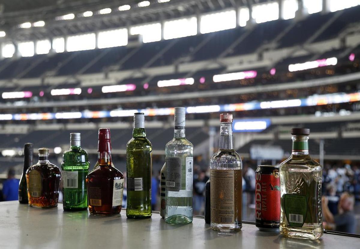 Various beers and liquors sit on top of a refrigerator in the West Plaza at AT&T Stadium.