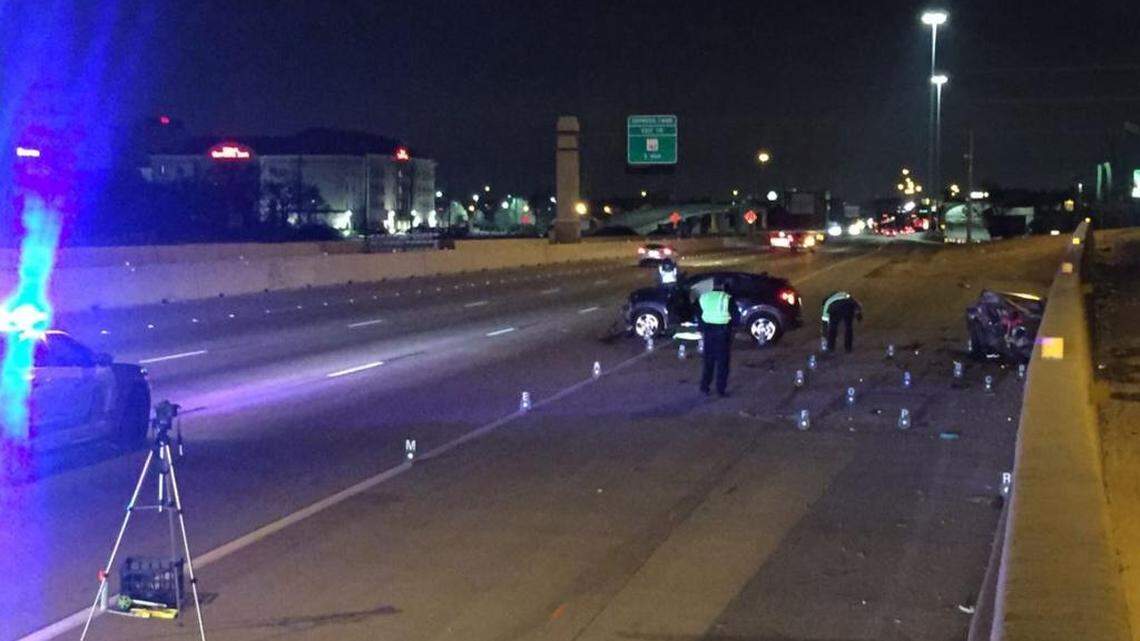 Arlington police investigators mark off debris in the shoulder of Interstate 30 early Saturday after a fatal wreck they say was caused by a drunk driver.