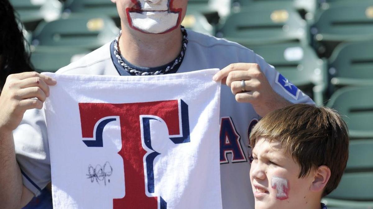 
William De La Paza, 34, and son Micah De La Paza, 10, of Arlington, watch batting practice as the Rangers play the Blue Jays in Game 4 of the ALDS at Globe Life Park in Arlington. The Rangers lost 8-4.
