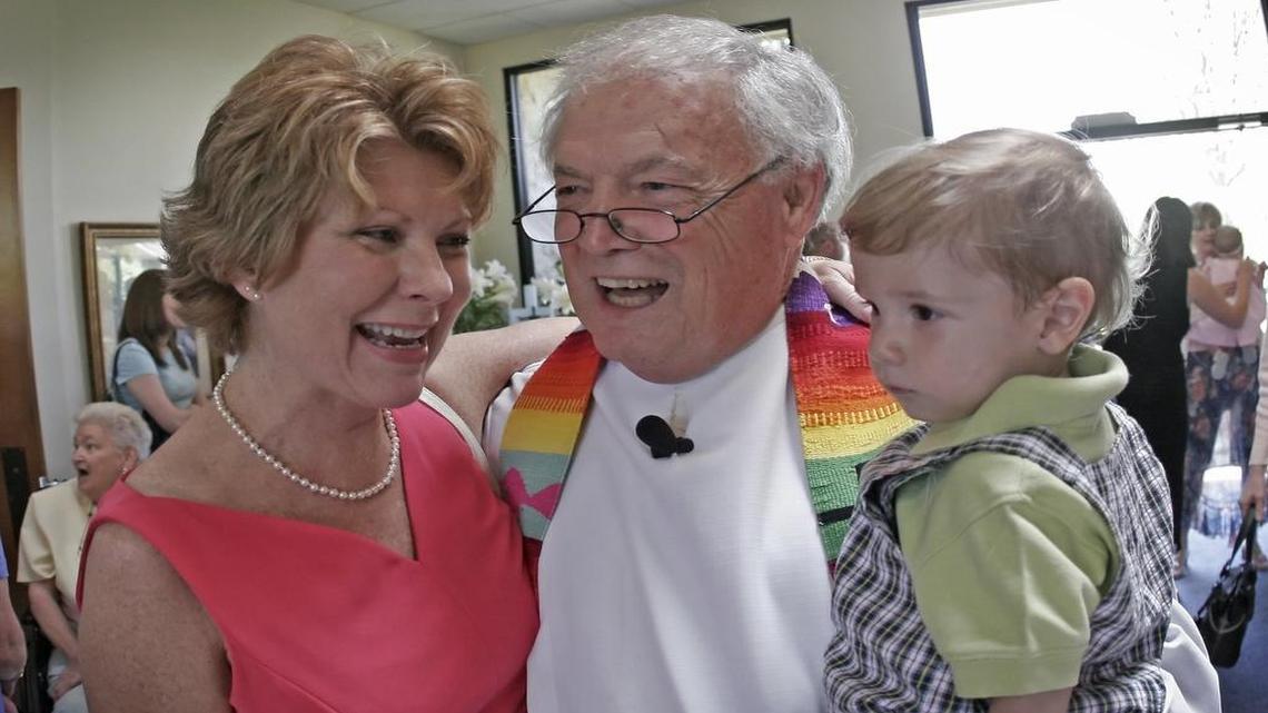 Rush Creek Christian Church Pastor Dick Lord, center, holds his grandson David, 18 months, as he talks with Connie Kerr after Easter Sunday services on April 16, 2006, a few weeks before his retirement.
