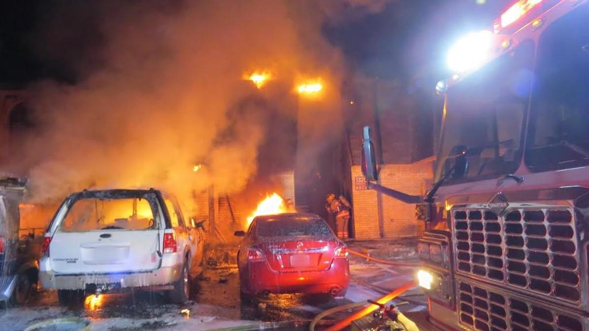 A fire damaged apartments and vehicles early Tuesday at the Park Row East Apartments in Arlington. No injuries were reported, but 18 residents were displaced.