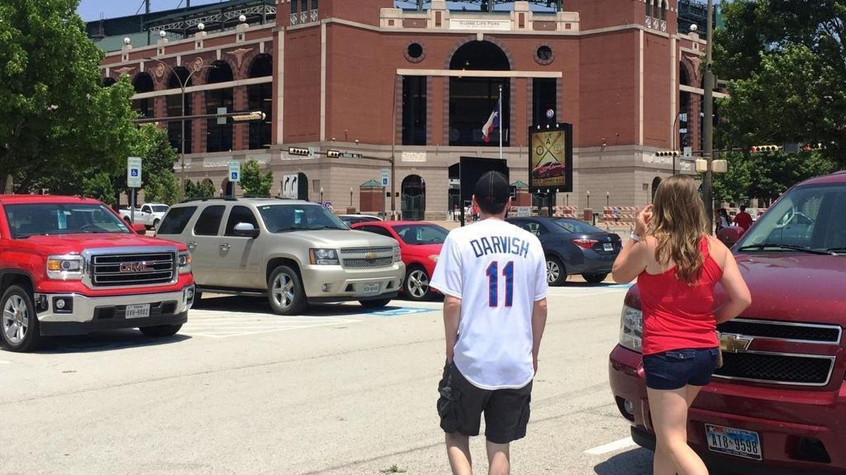 Texas Rangers fans walk through Lot A on their way to a game Wednesday in Arlington. The baseball club plans to convert seven acres of Lot A into a Texas Live! development, including pubs and restaurants, but hasn’t yet begun construction. (Wednesday, May 11, 2016)