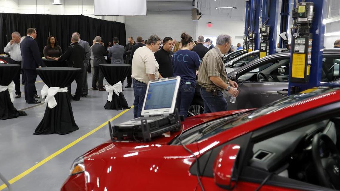 Officials and students mill around the automotive building at TCC’s South Campus as Toyota announces a new training program for service technicians.
