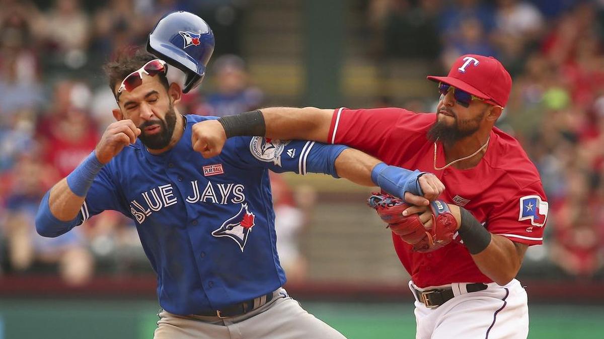 Toronto Blue Jays Jose Bautista (19) gets hit by Texas Rangers second baseman Rougned Odor (12) after Bautista slid into second in the 8th inning at Globe Life Park in Arlington Sunday May 15, 2016.