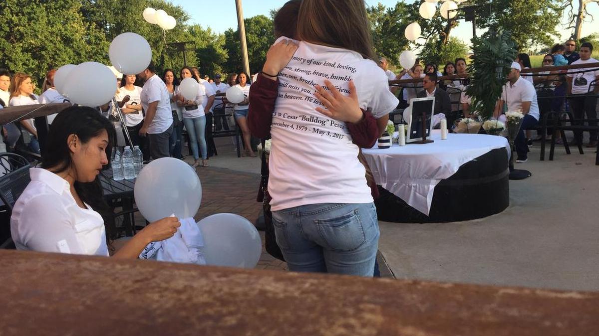 A vigil is held Thursday night for Cesar Perez, a manager at Zona Caliente Sports Bar and Grill in south Arlington who was fatally shot Wednesday night.