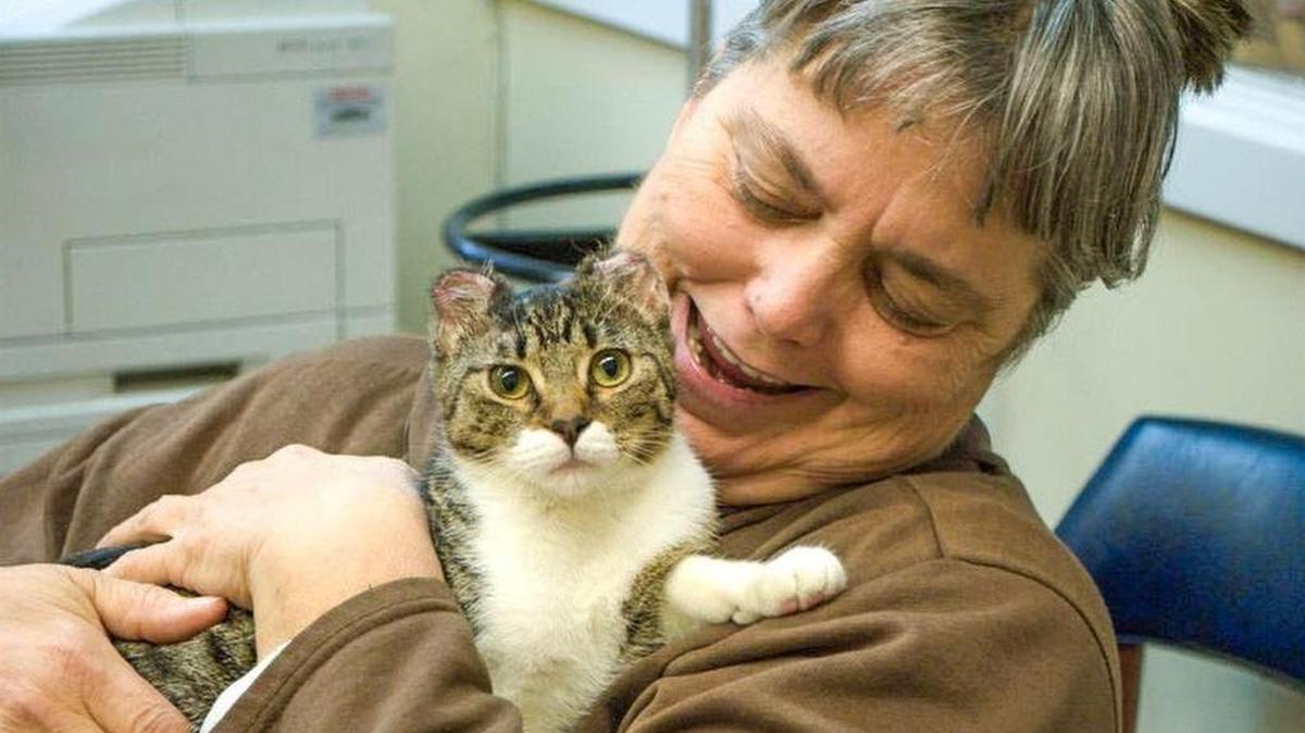Sherry Davis of Cedar Hill hugs her new family member, Blossom. The cat survived being set on fire in September near AT&T Stadium in Arlington. Davis adopted Blossom just a few days ago.