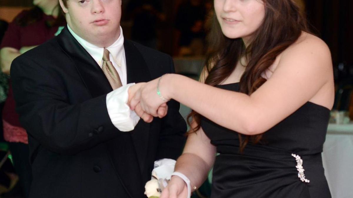 Kennedale students Daniel Carrington, left, dances with classmate Alexis Vega during the High school's special needs prom in the Kennedale High School cafeteria Saturday.
