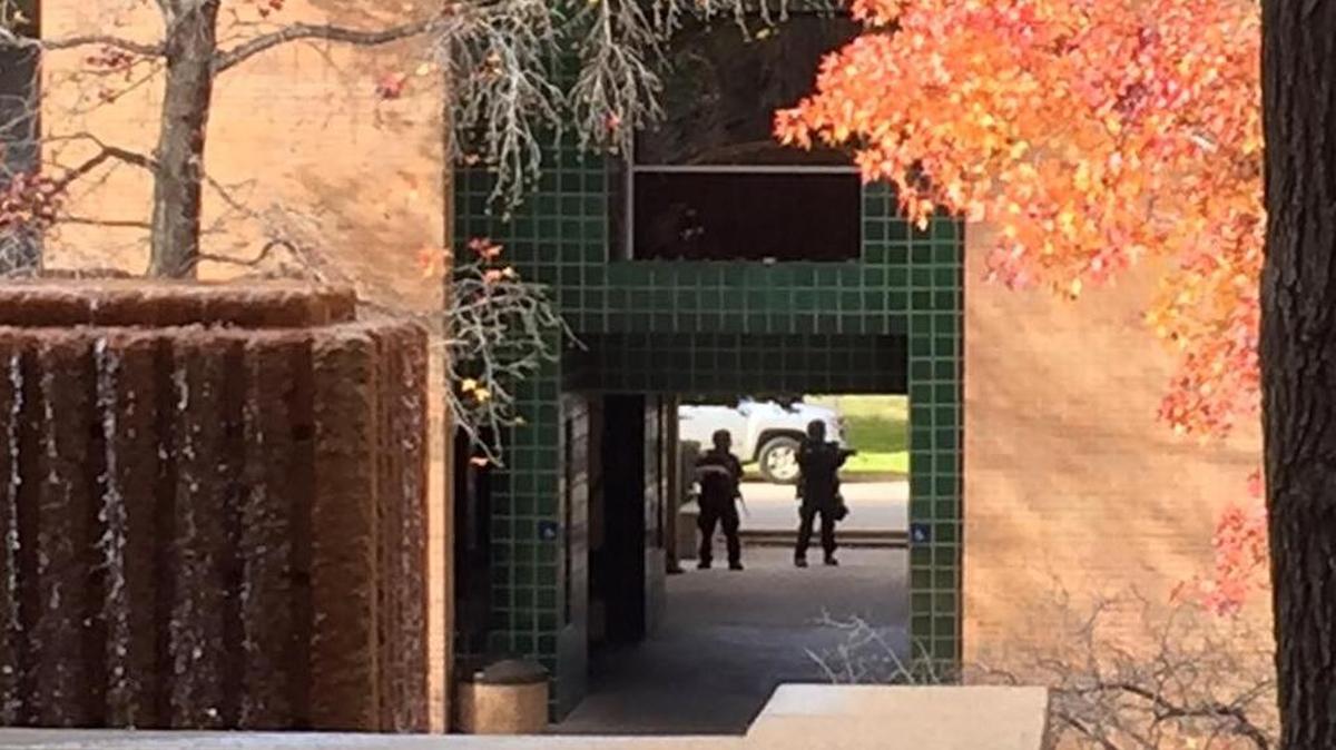 UTA police stand guard outside of the school’s architecture building Wednesday.