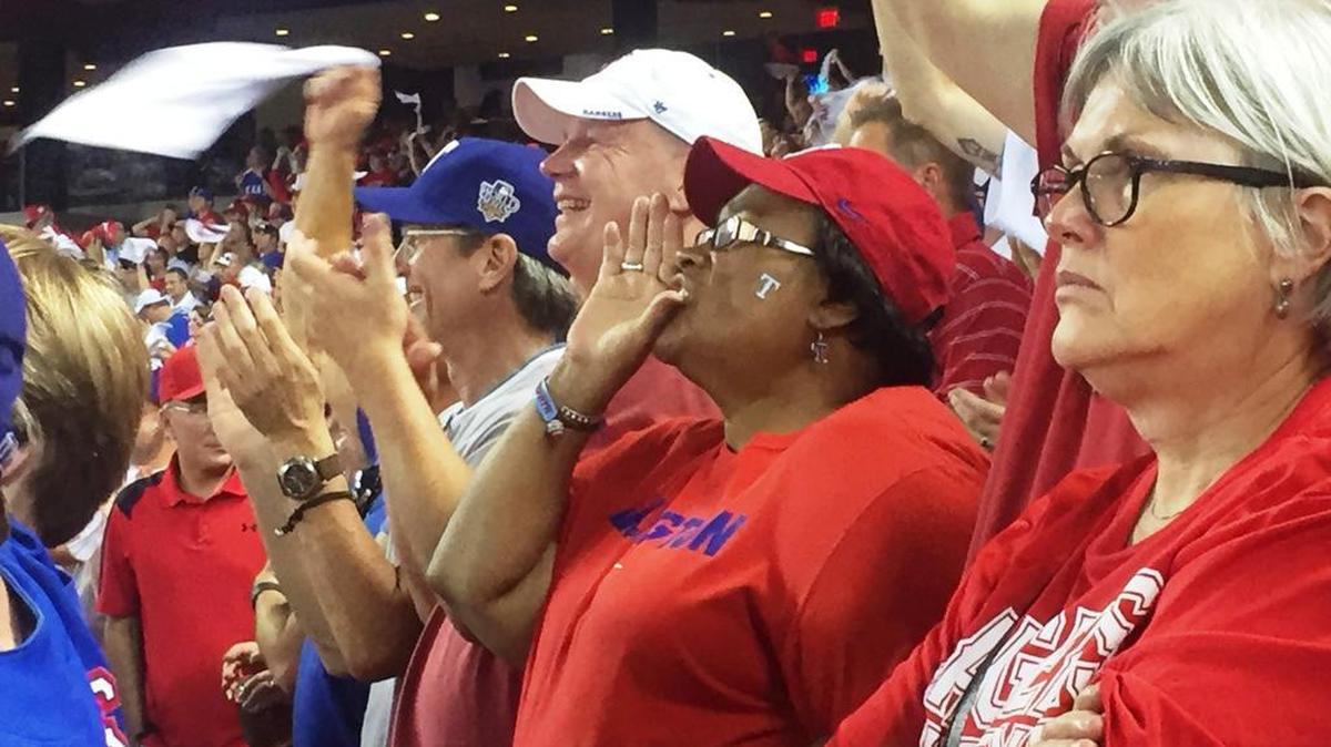 
Dawn Shepard shouts encouragement to her beloved Texas Rangers, who play the Toronto Blue Jays Wednesday in the American League Division Series.
