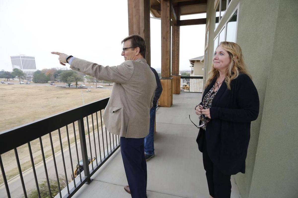 Robert Kembel, left, of Nehemiah Co. and operations manager Cindee Myers show off the view from the Arlington Commons on Dec. 18 in north Arlington. Kembel's company is also overseeing the Virdian development.