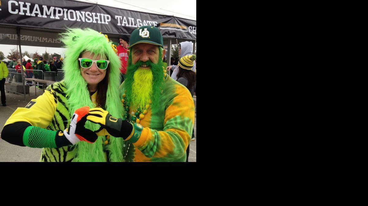 
Karna Jo and John Free of Olympia, Wash., flash the University of Oregon salute Monday outside AT&T Stadium in Arlington.
