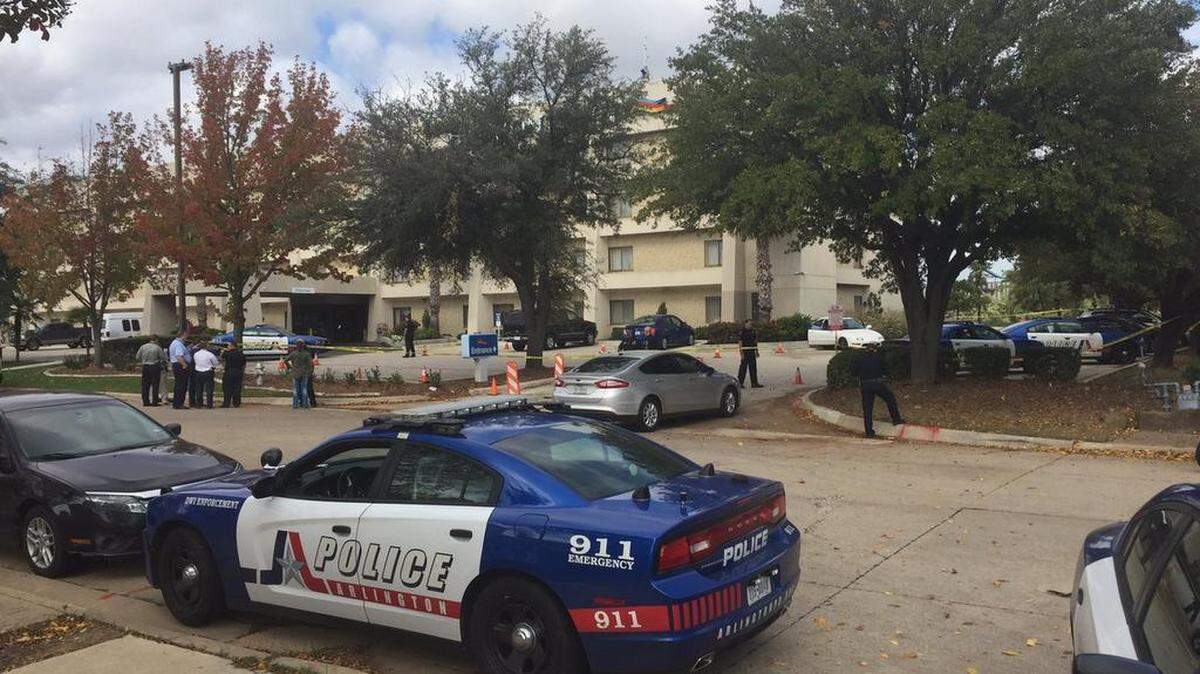 An Arlington police officer shot a car theft suspect Friday, after the suspect backed into one officer and an open vehicle door struck another, police said.