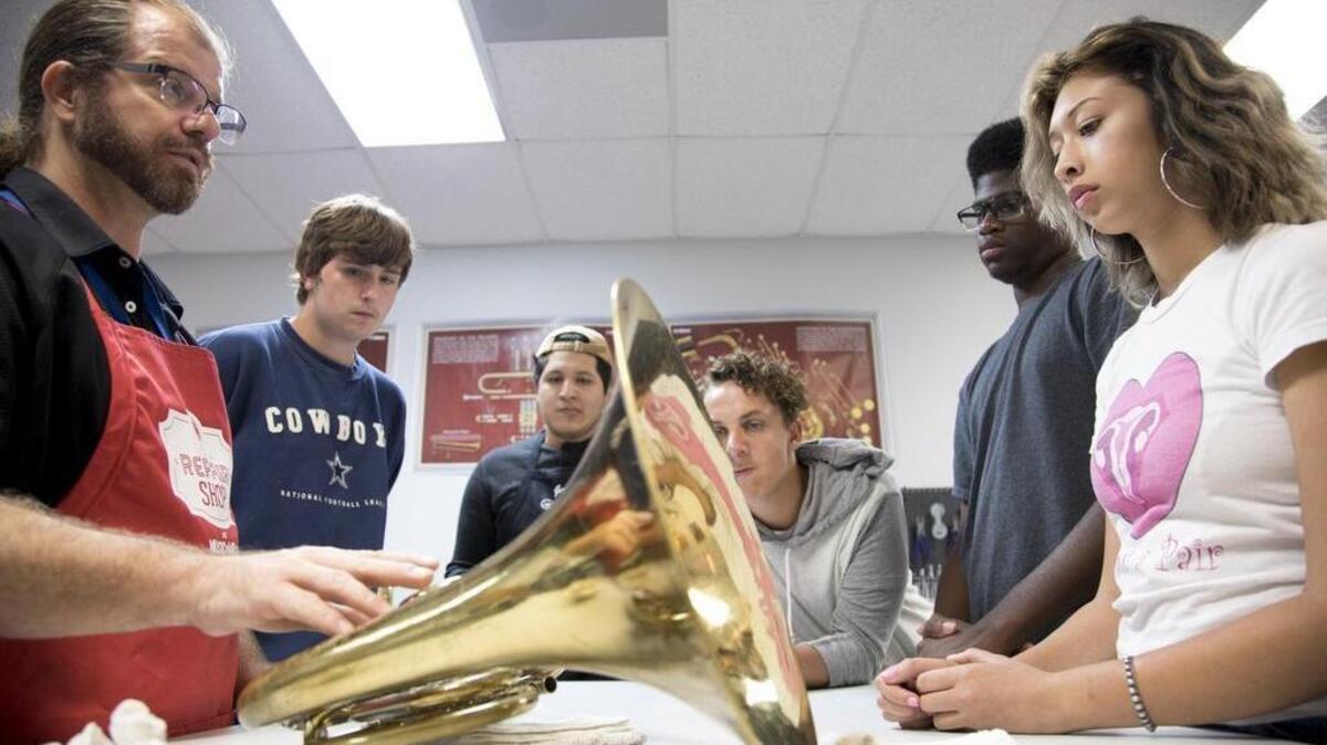 Musical instrument repair teacher Joe Strohl begins a lesson by explaining the intricacies of a double horn during an instrument repair class Thursday at Bowie High School in Arlington. The class is a partnership between the Arlington school district and Music & Arts to bring education and about $150,000 of equipment to assist in the students’ hands-on learning.