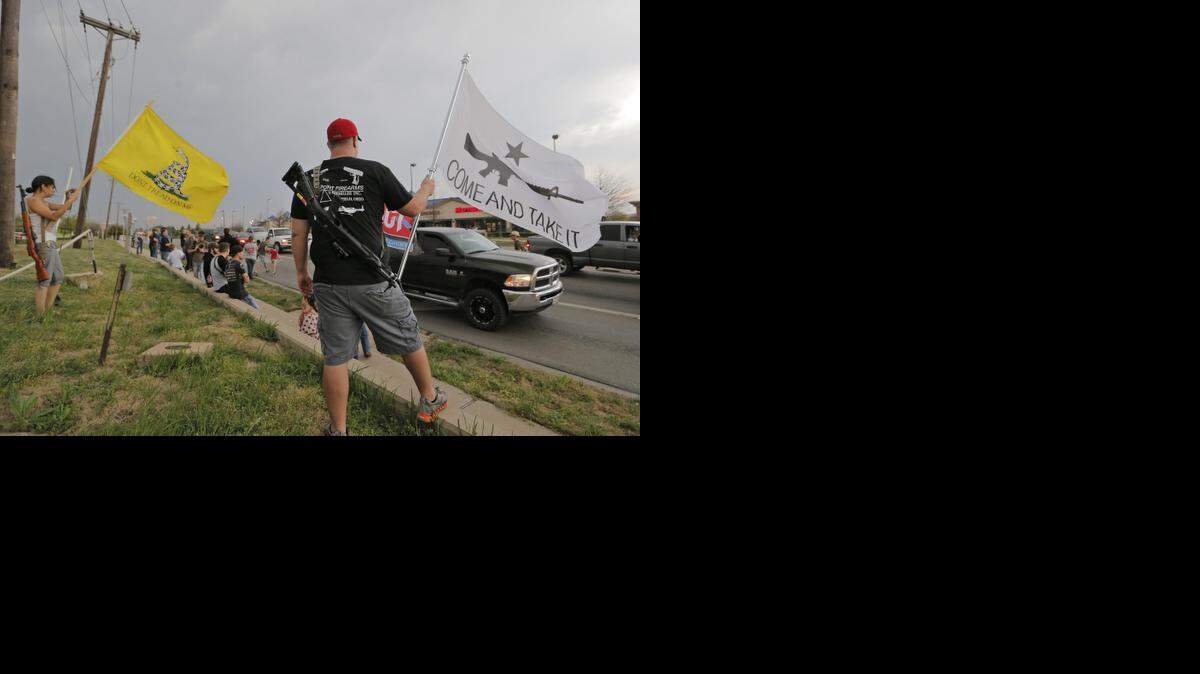 
Chris Donawho, of Arlington, carried a flag and his .45 caliber tactical carbine rifle as members of Open Carry Tarrant County gathered in Mansfield earlier this year to demonstrate for laws allowing the open carrying of hand guns.
