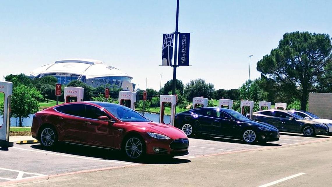 Tesla Model S and X electric cars line up at a new Tesla Supercharger station during an grand-opening ceremony on May 13 in the Arlington Convention Center parking lot.