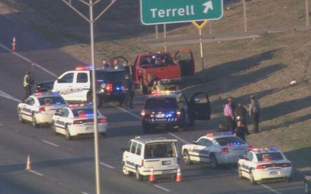 
Police surround a red pickup on a shoulder of Interstate 635 in Mesquite after the driver shot himself and a passenger, a suspect wanted in Arlington, was arrested.
