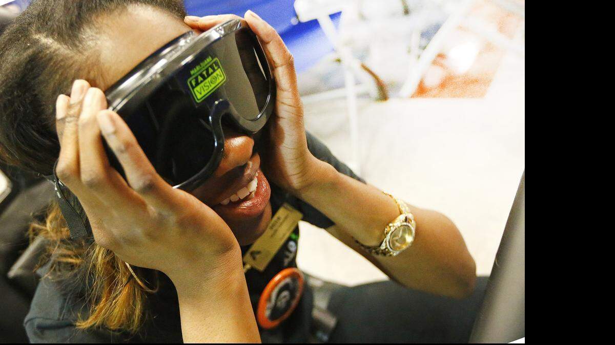 
UT Arlington sophomore Ty Rhodes reacts Friday after participating in a drunken-driving simulator. Students drove pedal karts through an obstacle course while wearing Fatal Vision goggles to learn firsthand the effects of alcohol on vision and motor skills. The U in the Driver Seat program is holding its Peer-to-Peer Impaired Driving Prevention Symposium at the University of Texas at Arlington through Saturday.
