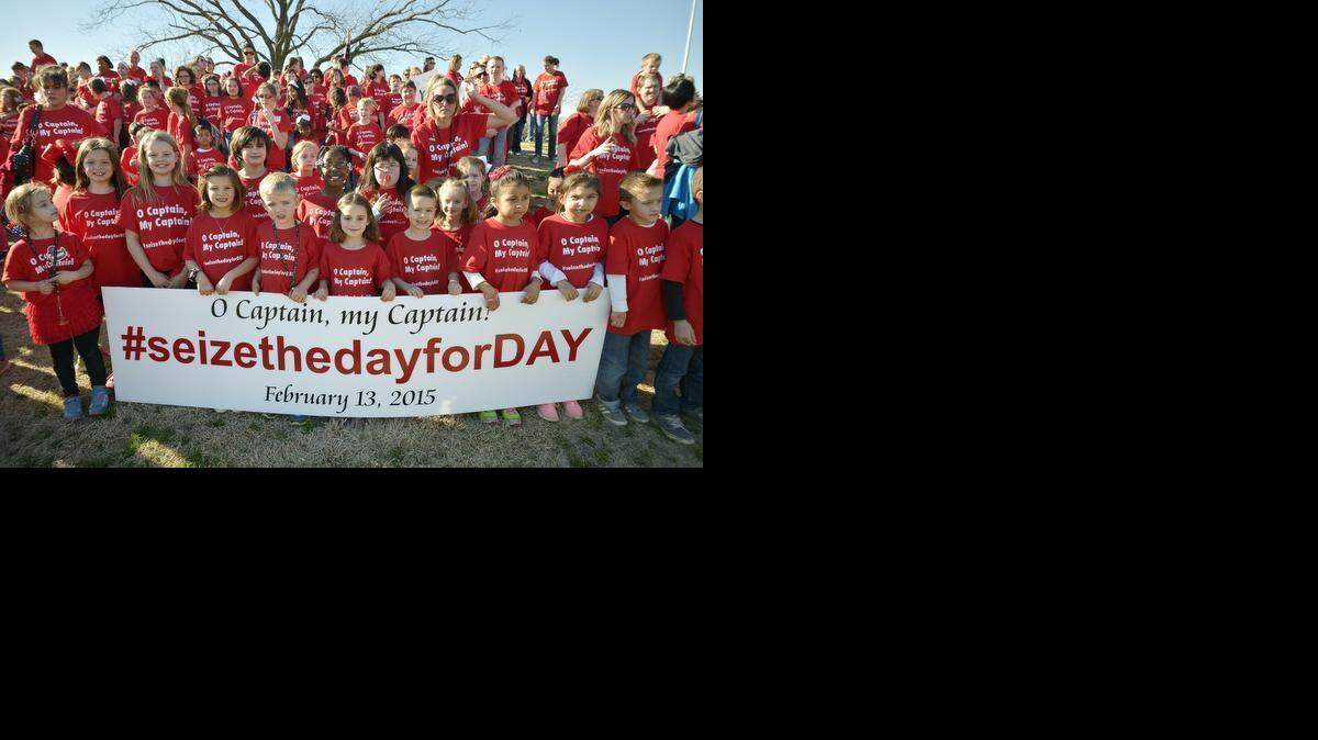 
Members of the Hill Elementary School PTA and a bunch of elementary students wear shirts that say, “O Captain! My Captain! #seizethedayforday” to honor their former principal, Lloyd Day, who parents say was forced to retire by the Arlington school district. The parents and kids gathered at a park near Hill Elementary School on Friday to have a photo taken in support of Day.
