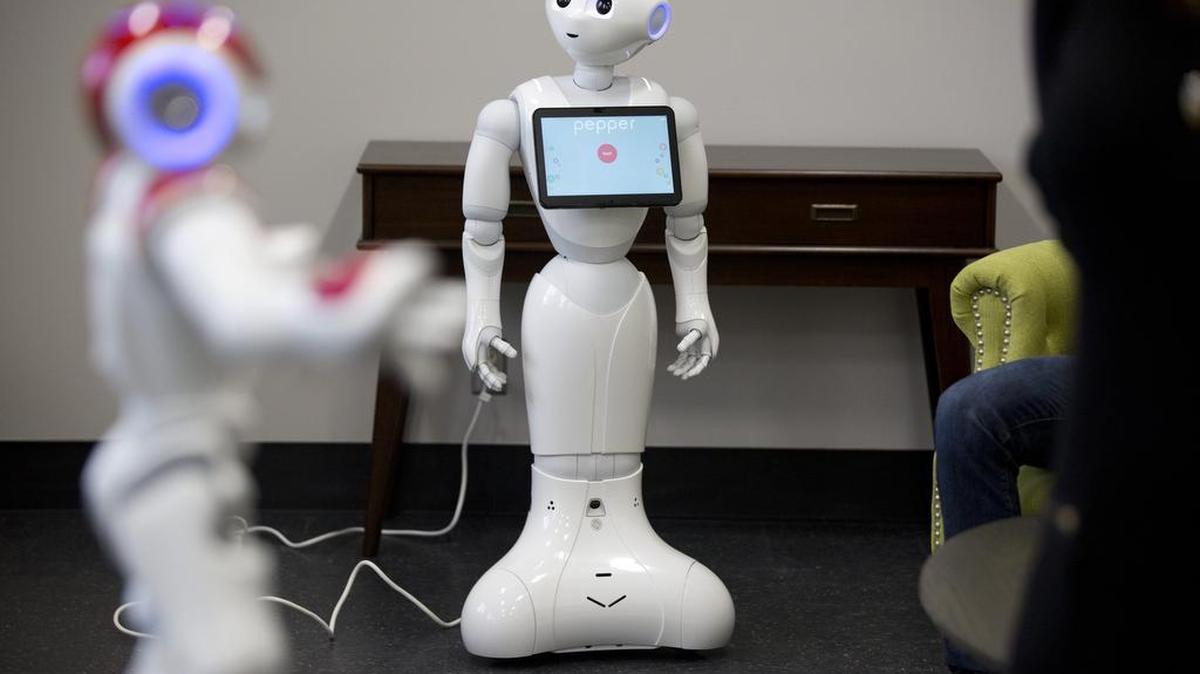 A robot named NAO, left, and Pepper in the backgroundnew Emotional Robotics Living Lab at UTA on Tuesday.