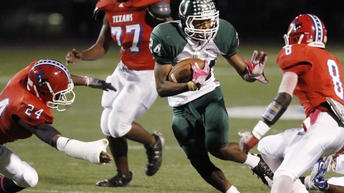 Arlington High senior running back Tavarreon Dickerson (24)(cq) looks for room against Sam Houston during a high school football game October 13, 2011, in this archive photo. Dickerson is now in jail facing a first-degree murder charge.