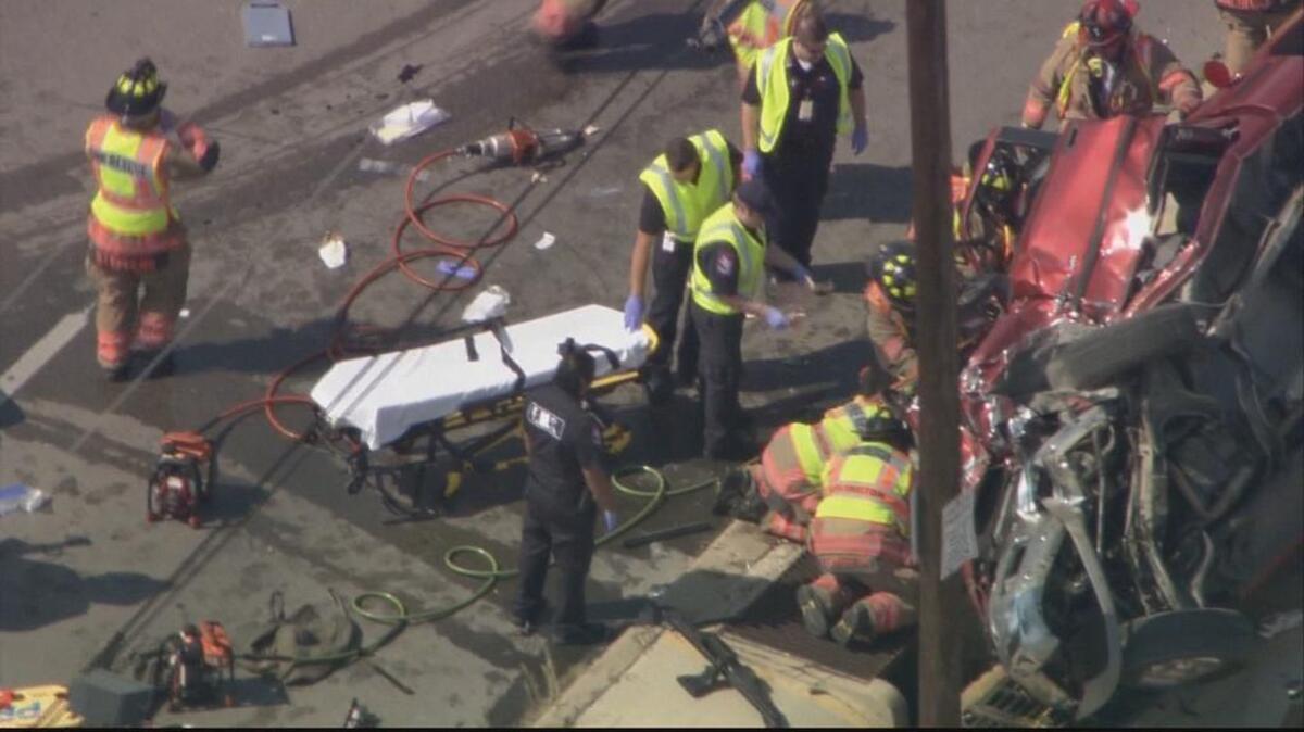 
Arlington first responders work to extricate people in a pickup that was hit by a car driven by a robbery suspect being chased by police on Friday, Sept. 25, 2015.
