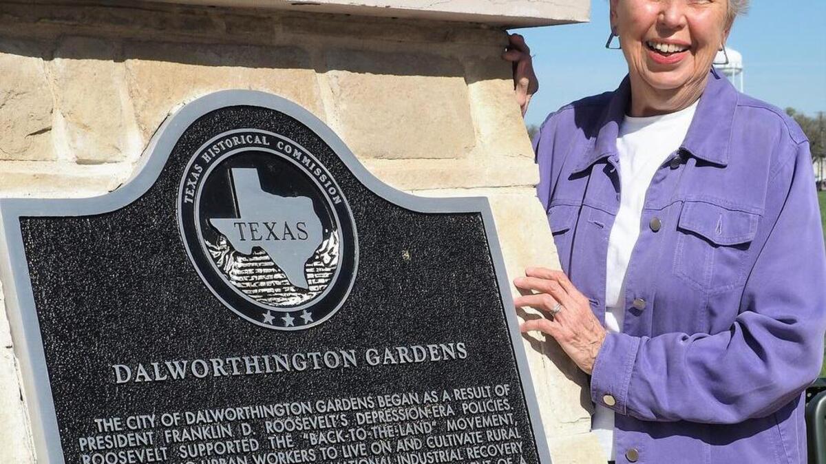 Dalworthington Gardens historian Velma Bogart with the state historical plaque that tells the town’s story.