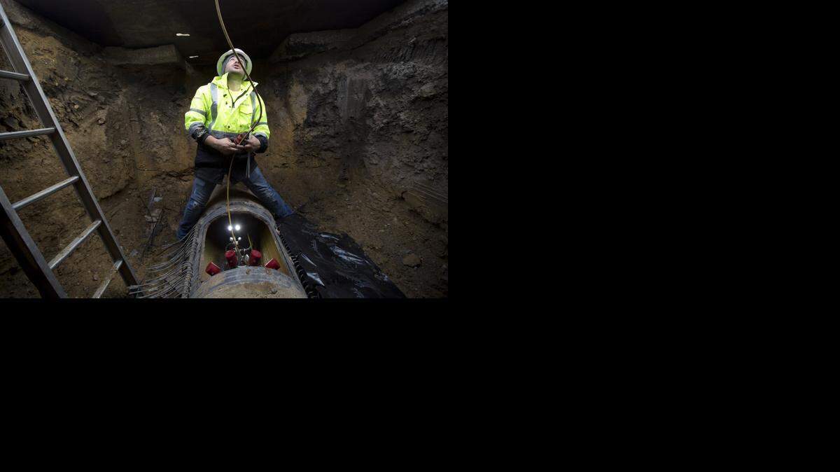
Pure Technologies field tech Edgar Munoz prepares the robot that will assess the condition of the 24-inch water main under Stadium Drive in Arlington.
