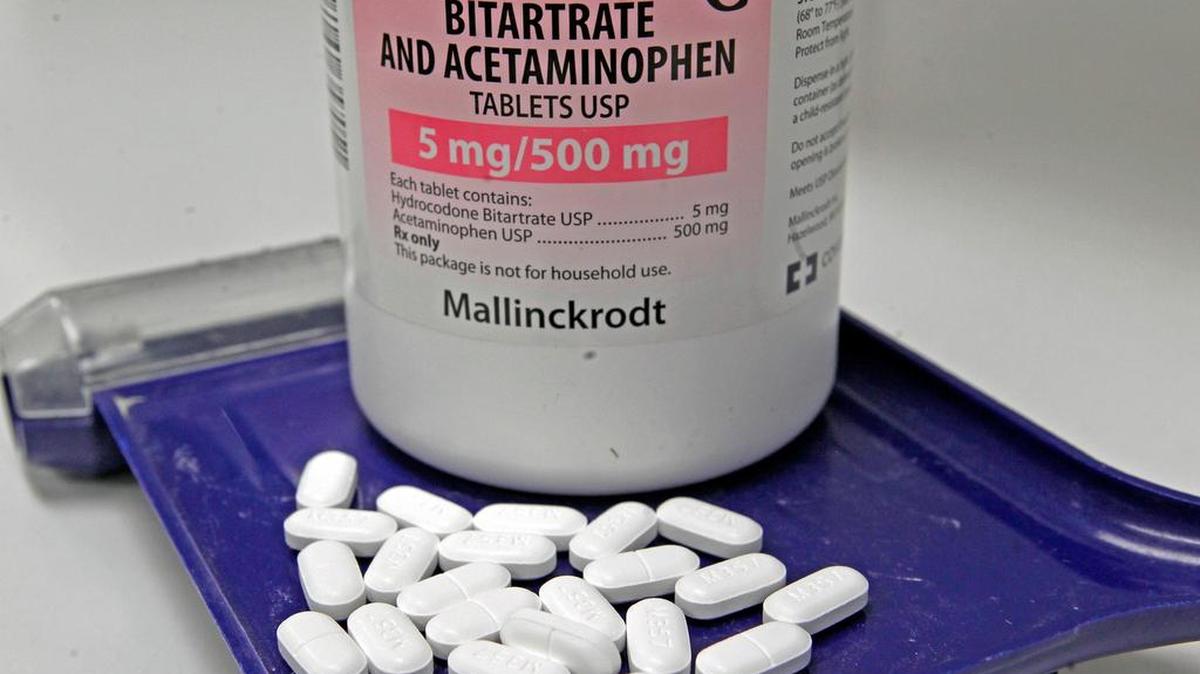 An Arlington pharmacist was indicted Wednesday, accused of using homeless and low-income recruits to illegally sell painkillers.
