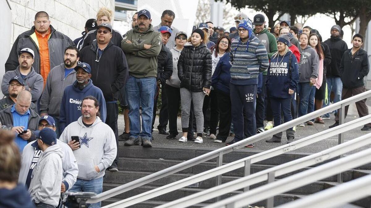 Fans lined up to buy Dallas Cowboys playoff tickets at AT&T Stadium in Arlington on Dec. 28. Since then, prices for playoff tickets have soared on secondary websites.