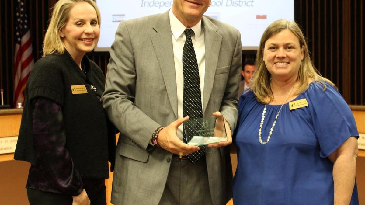 Superintendent Robin Ryan receives the Big Brother of the Year award from Melanie Hanna, Market President for Greater Tarrant Big Brothers Big Sisters (left) and Jennifer O’Leary, Match Support Coordinator.