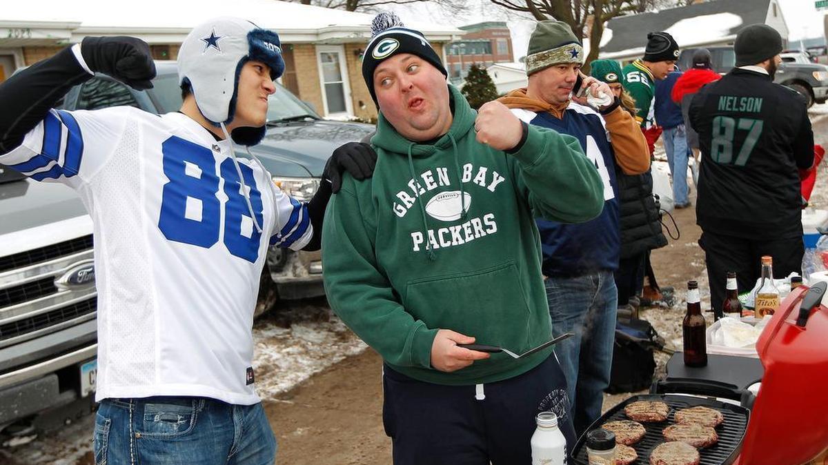 Dallas Cowboys fan Patrick Watkins and Green Bay Packers fan Ben Bjerk trade barbs near Lambeau Field before the teams played in an NFC divisional round playoff game on Jan. 11, 2015.
