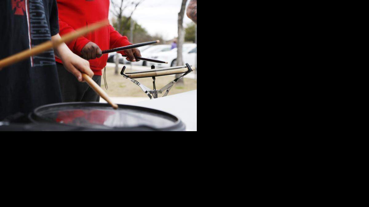 
Zachary Gilbreath, 13, left, and Gregory McHenry, 14, practice drumming during the Drumming Around Town event Saturday at the Southeast branch Arlington library. 

