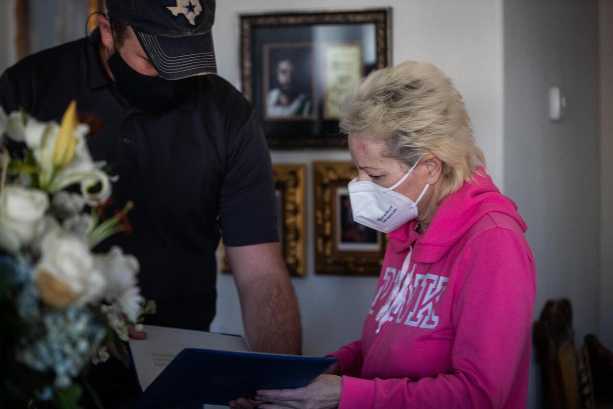 Officer Cory Rattan brought Heidi Stokes a certificate and gifts from the Southlake Police Department to commemorate her husband, Sgt. John Stokes, who died suddenly Nov. 29, 2020.