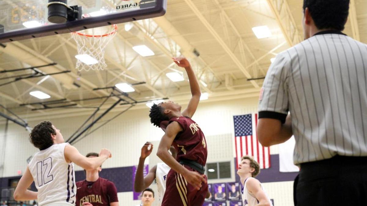 Latrell Jossell shoots a reverse layup in recent district action.