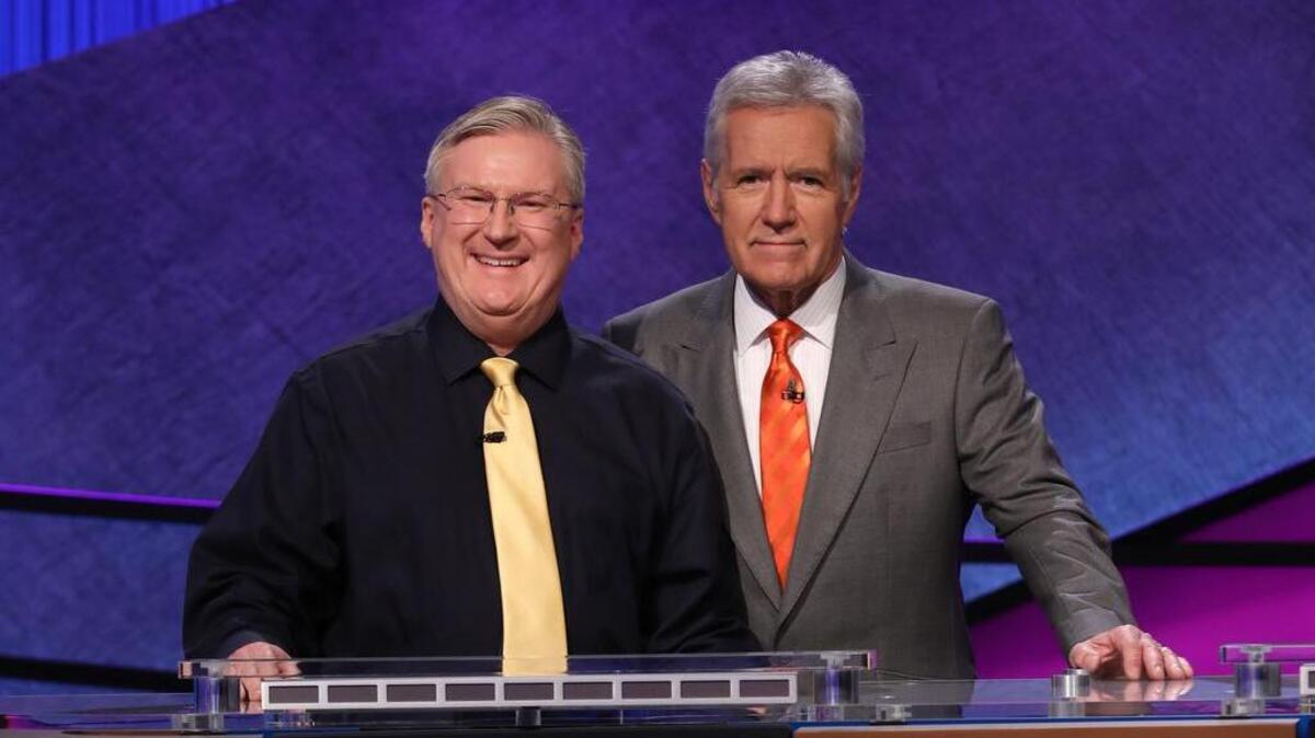 Keller High history teacher David Clemmons poses with “Jeopardy” host Alex Trebek. Clemmons is one of 15 teachers in the game show’s 2017 Teachers Tournament.
