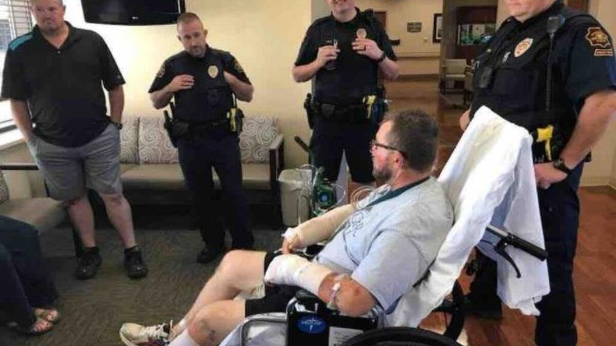Grapevine officers Willie Lain, Caleb Goodman, Chad Hale and Greg Ross visit officer R.J. Hudson while he is on the mend.