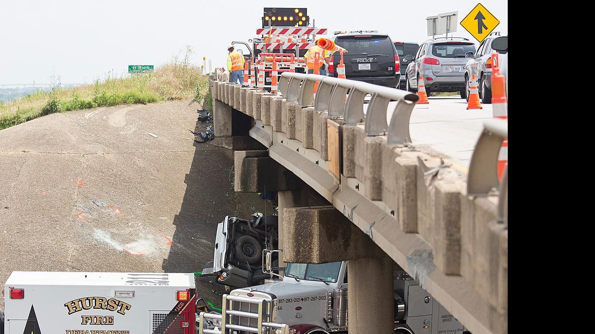 
Hurst emergency crews respond to the scene of a fatal accident at Loop 820 southbound in Hurst, TX on May 23, 2015. Investigators believe the rain-slick highway caused the vehicle to flip, killing two women and one man. 
