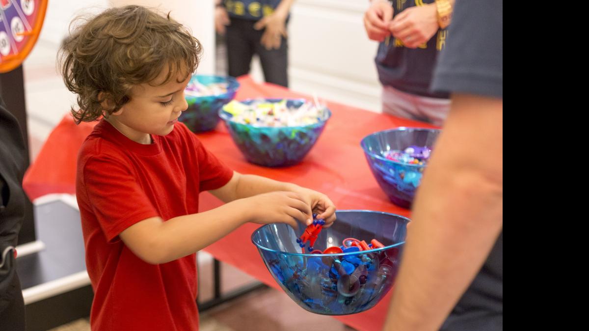 
Dylan Morris, 6, picks a toy out after spinning a prize wheel.



