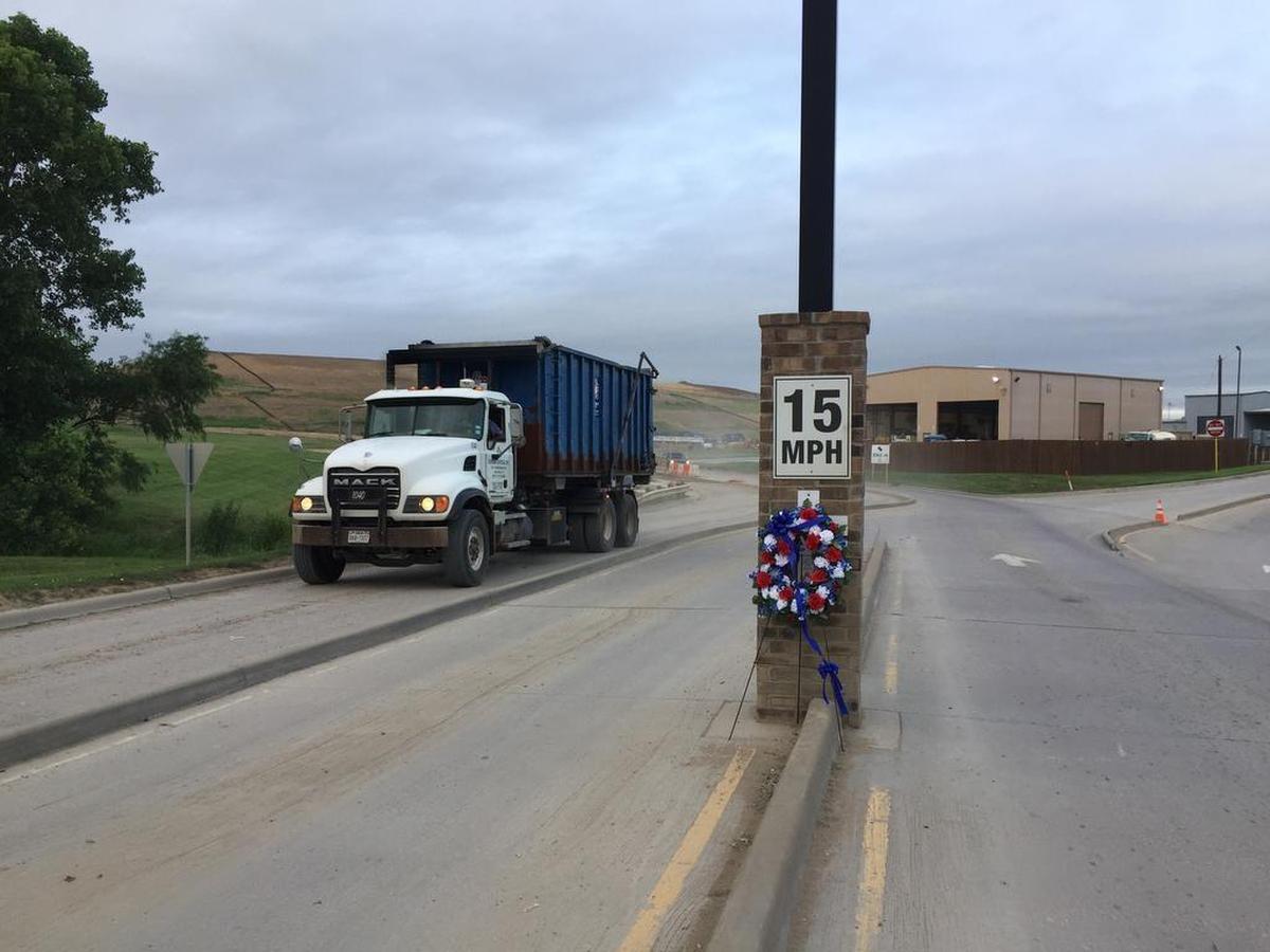 A wreath was outside the Arlington landfill on Thursday, but it was not related to the body found there on Wednesday.