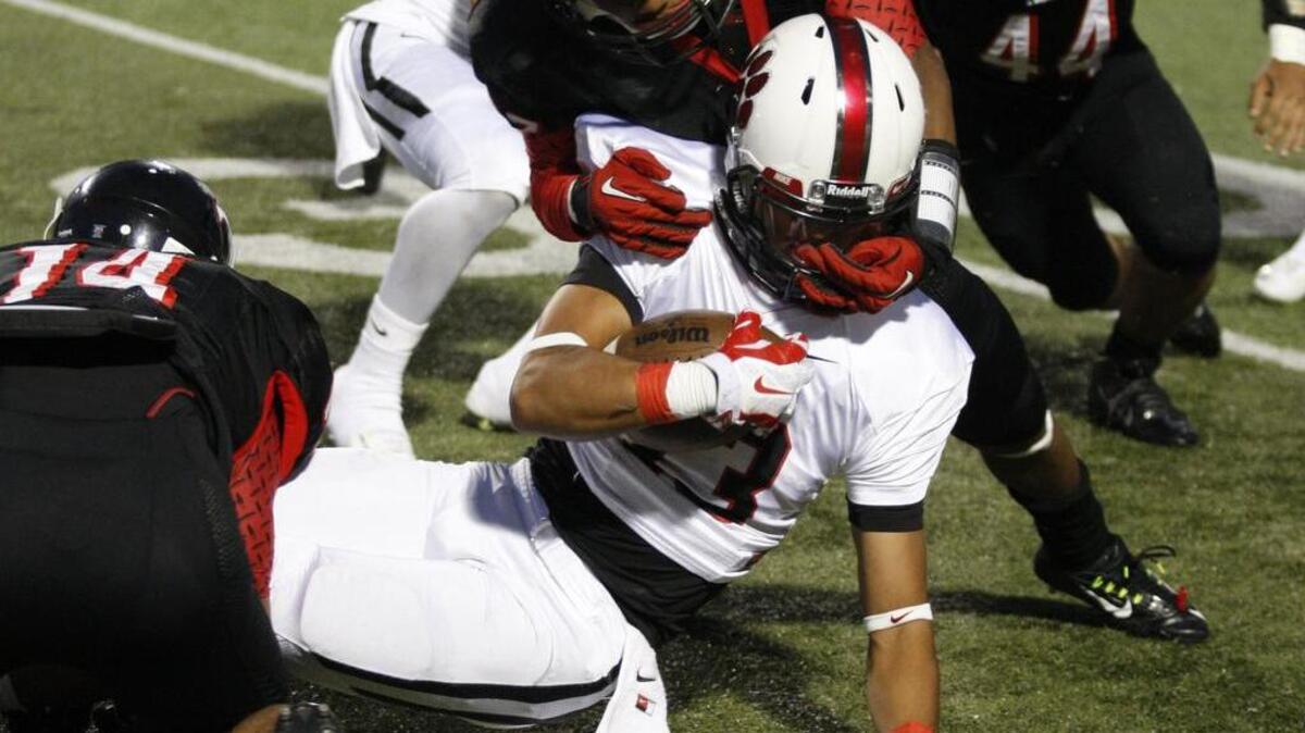 
Trinity corner A.J. Jackson tackles Colleyville wide receiver (13) Kevin Salinas last fall. Jackson is also a track and field standout.
