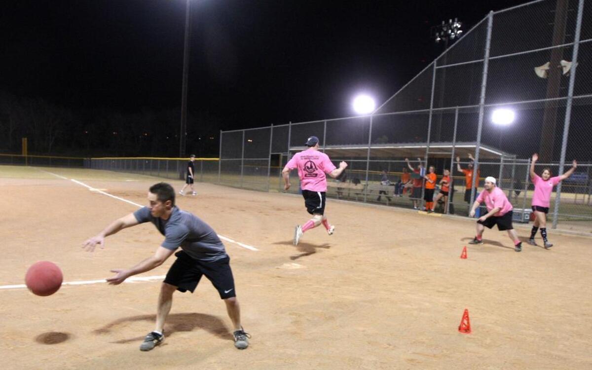 People play co-ed adult kickball at Gateway Park in Fort Worth. A summer league is registering teams in Grapevine.