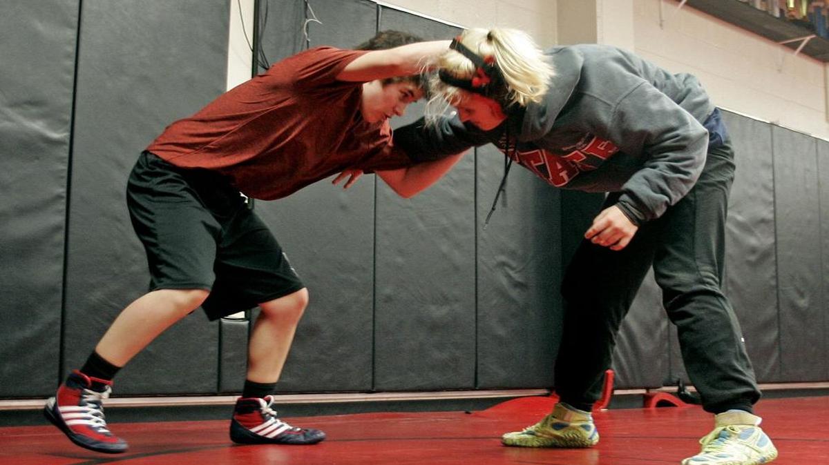 Mack Beggs (left) and Elizabeth McKenzie practice grips and releases during wrestling practice at Trinity High School recently.